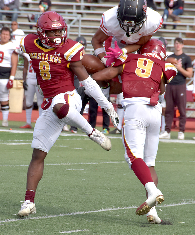 Safetys Quatama Massoquoi and Khi-ron Green close in on an Owls receiver to break up a pass. 