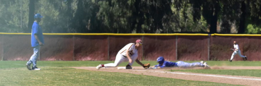 Los Medanos Mustangs baseball player Ryan Pierce, No. 18, tags a Solano Falcon runner out at third base.
