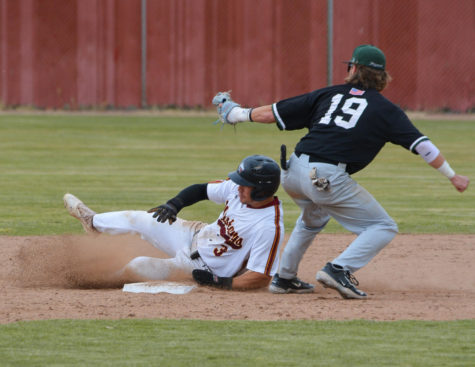 Los Medanos Mustangs baseball player Seth Gwynn slides into second base safely to get closer to scoring for LMC.