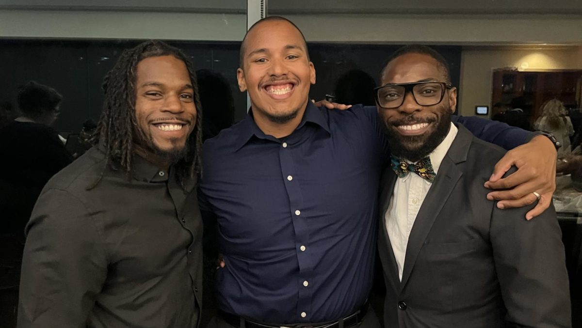 From right: Yost Kalasa, Andrew Murphy and Antonio Johnson pose for a photo at a Brothers of Excellence dinner.