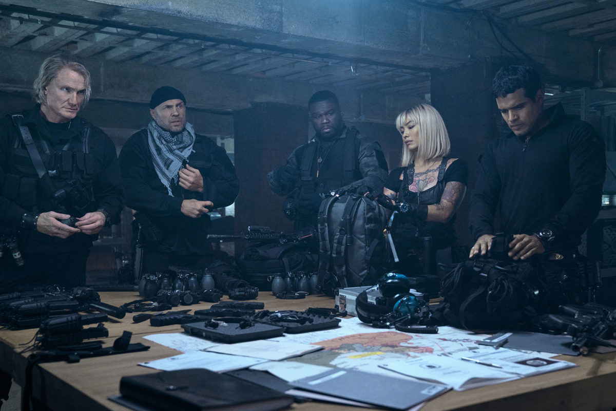 From left: Gunner Jensen, Toll Road, Easy Day, Lash and Galan go over the plans for the second mission within the movie Expend4bles.