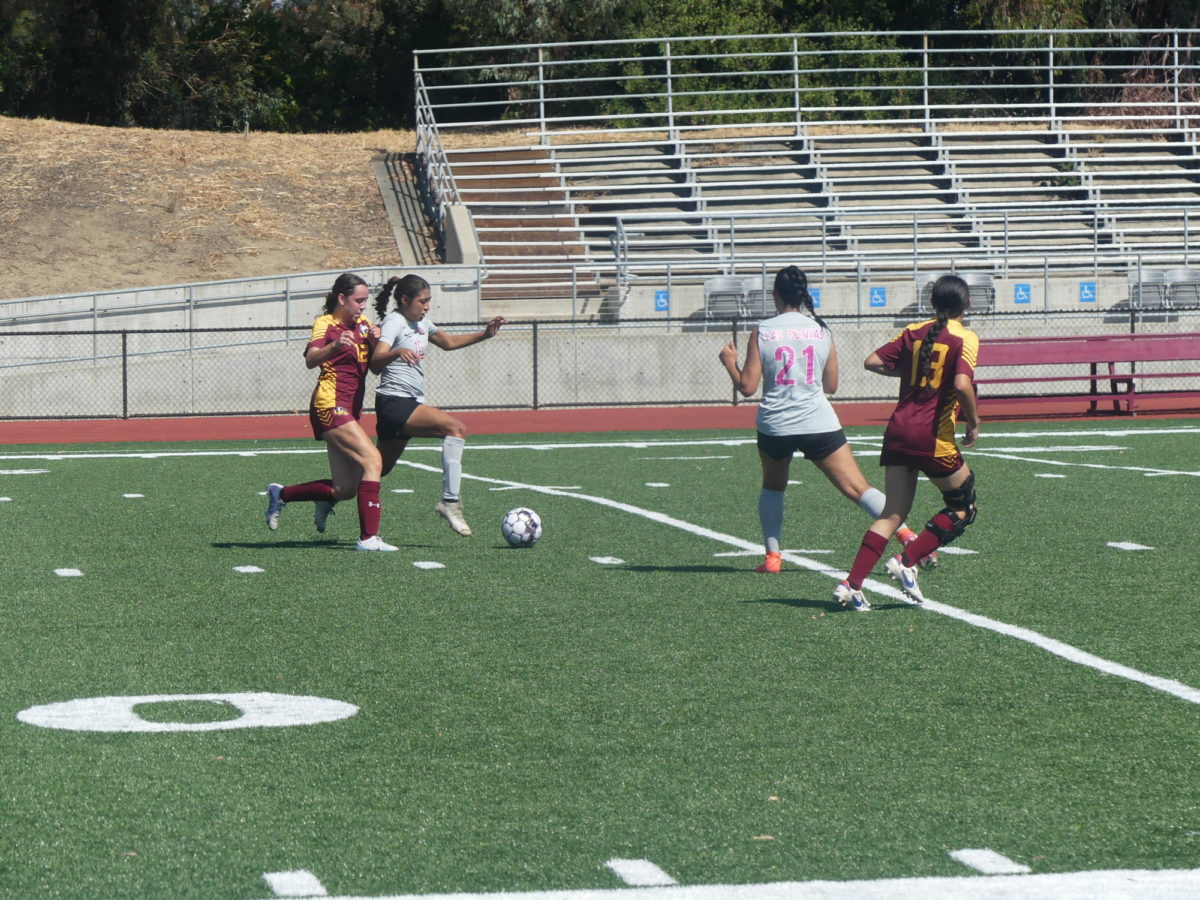 Los Medanos Mustangs womens soccer forward Reina Ramos-Hall attempts to steal the ball from a hawks attacker.