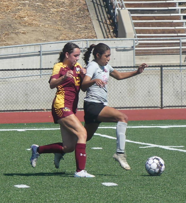 Los Medanos Mustangs womens soccer forward Reina Ramos-Hall attempts to steal the ball from a hawks attacker.