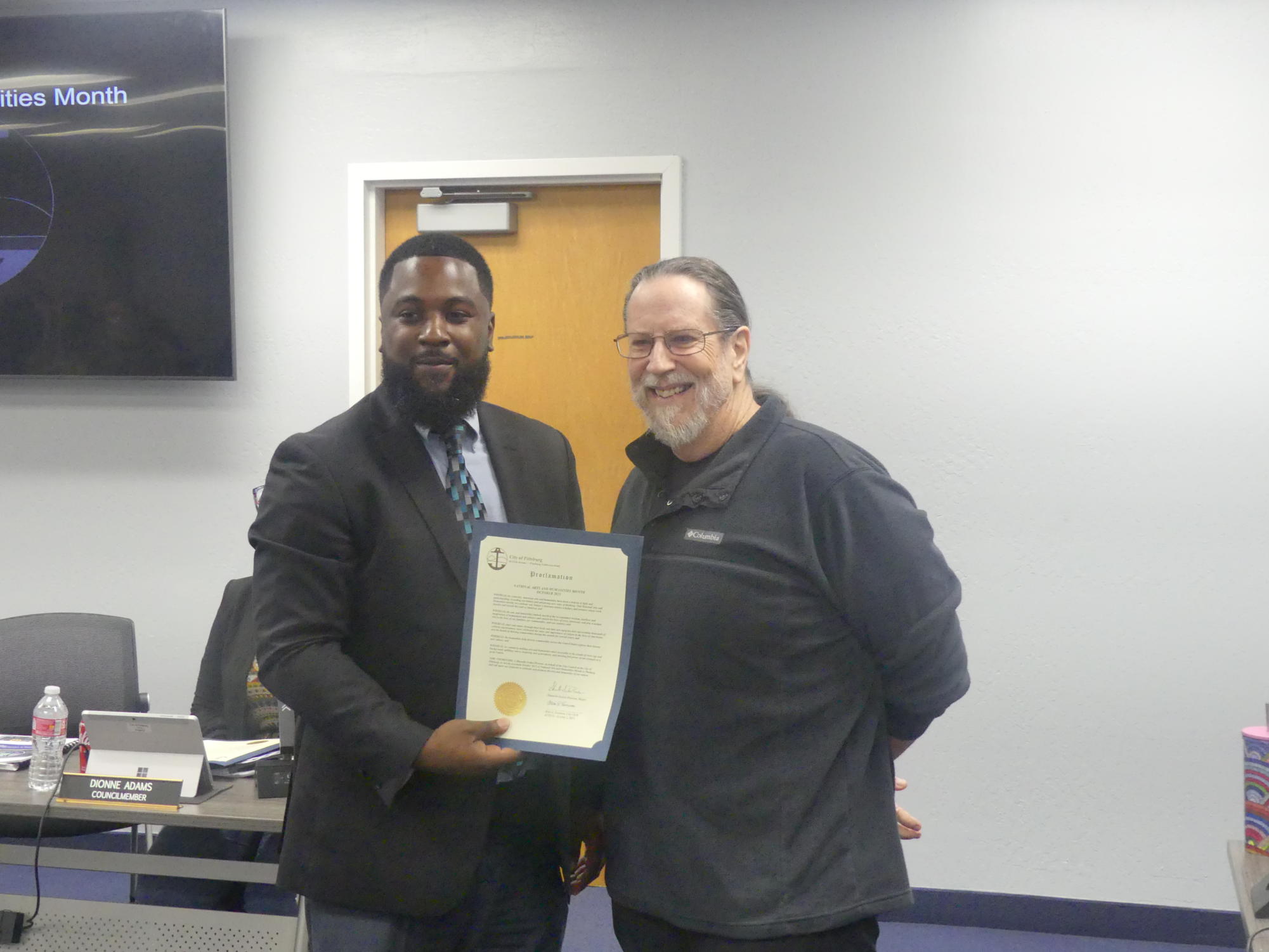 LMC Art Professor Ken Alexander posing for a photo as he is awarded a Proclamation for recognition of Arts and Humanities month by Pittsburg Councilmember Jelani Killings.