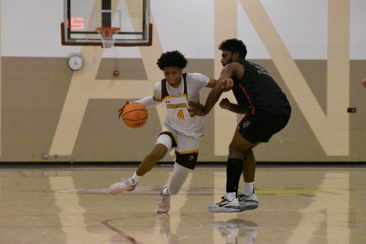 Los Medanos College Mustangs mens basketball player Ramon Bailey, No. 4, drives to the basket trying to get around the defender.