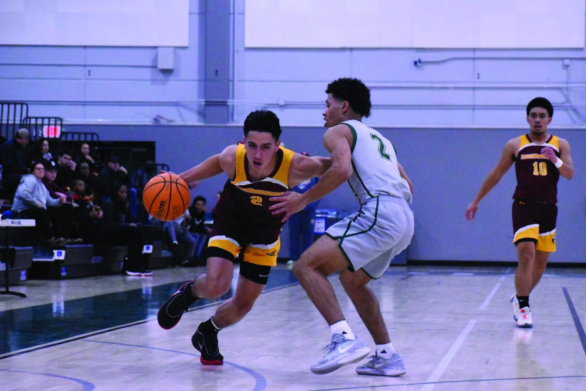 Los Medanos College Mustangs mens basketball player Devin Carson, No. 2, drives around the defender to the basket looking to score.