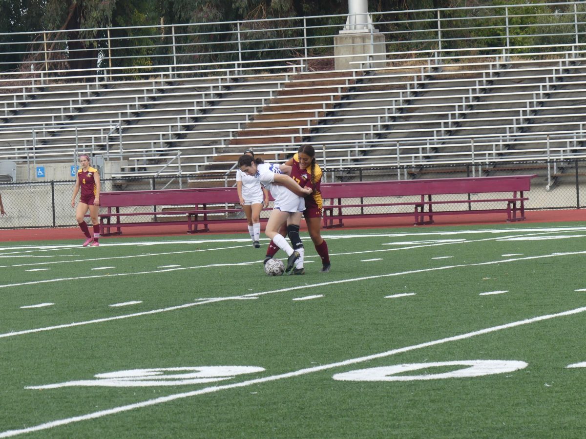 Los Medanos College Mustangs womens soccer player Zuleyka Berumen attempts to steal the ball from the Comets player.