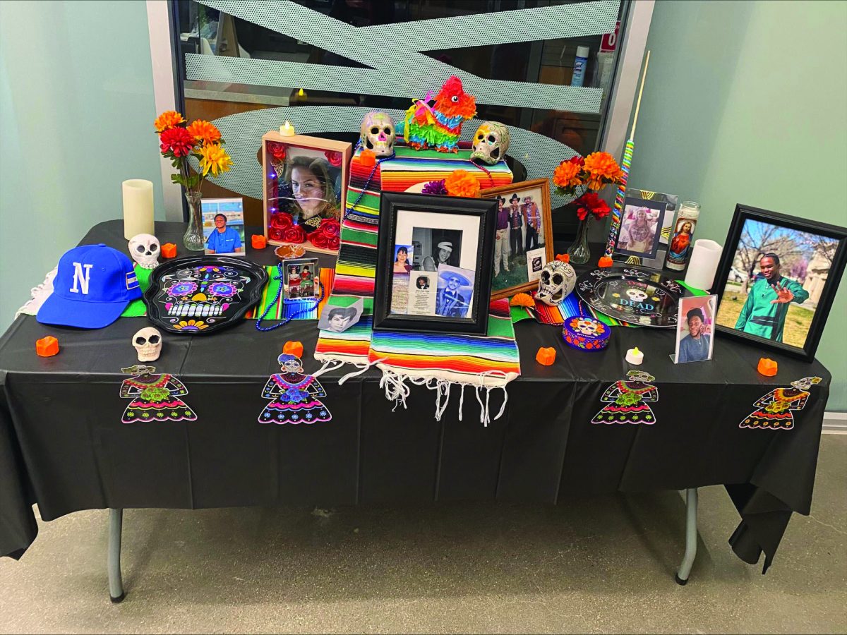 Photos+of+late+loved+ones+are+displayed+on+an+altar+for+Dia+de+los+Muertos+event.