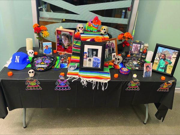 Photos of late loved ones are displayed on an altar for Dia de los Muertos event.