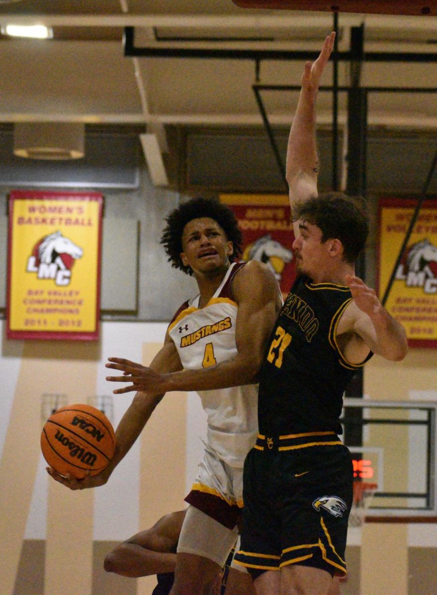 Mustangs guard Ramon Bailey fights through contact to attempt a layup in the Mustangs 78-64 win against Mendocino College. 