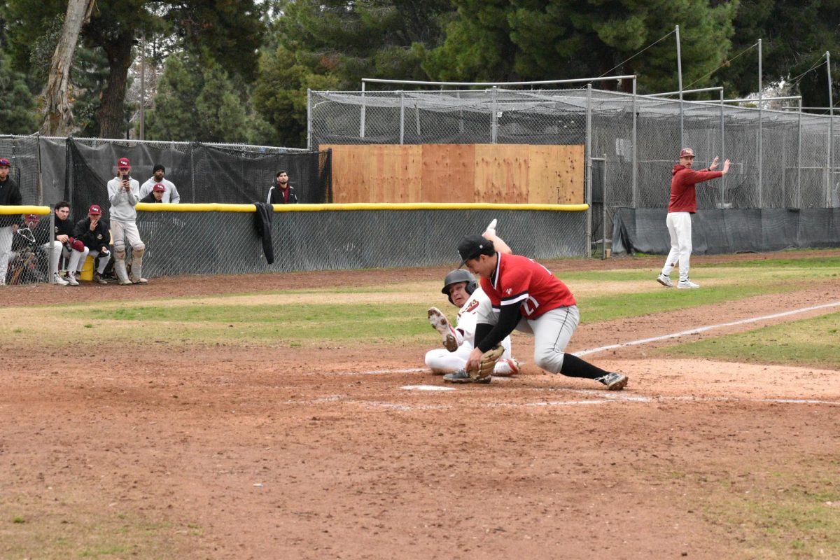 In an attempt to steal home on a passed ball, Mustangs runner Anthony Manuel is tagged out by pitcher Cristian Padilla.