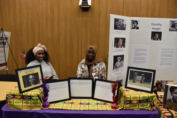 Ebun Femi-Olojo and Safiat Badiru at the Umoja scholars table with a presentation on Dorothy Height.