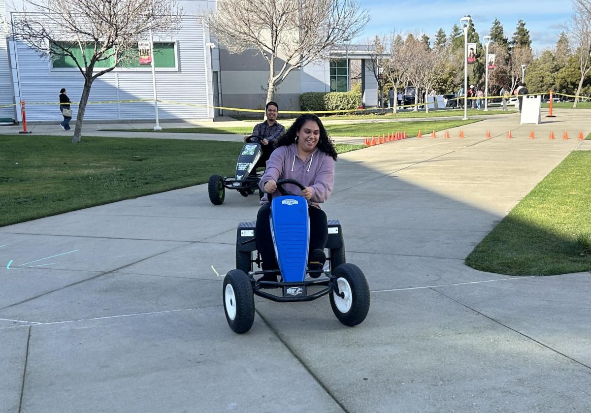 Los Medanos College student Annie Villa leads another student in a go-kart race during the Welcome Week celebration at the Pittsburg campus. 