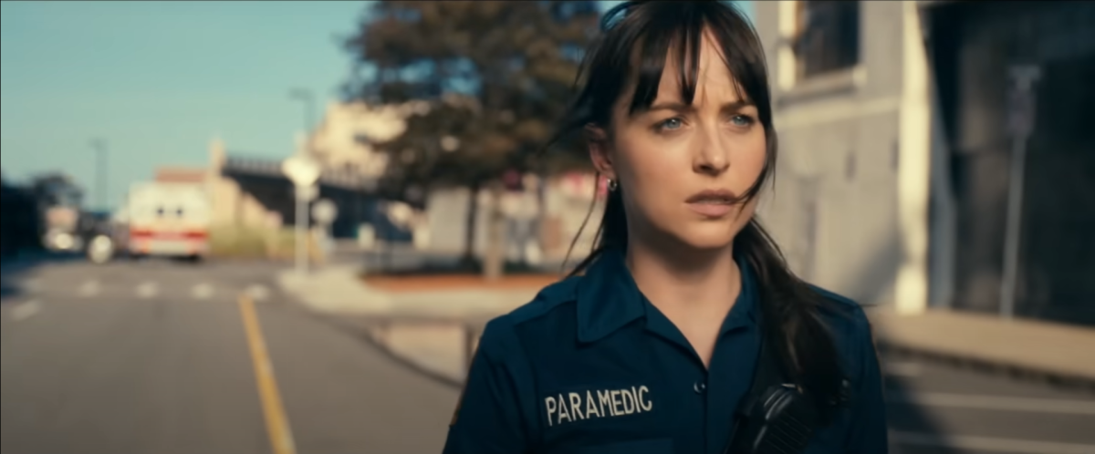 Cassandra Webb, portrayed by Dakota Johnson, walks away uncertainly as danger looms.