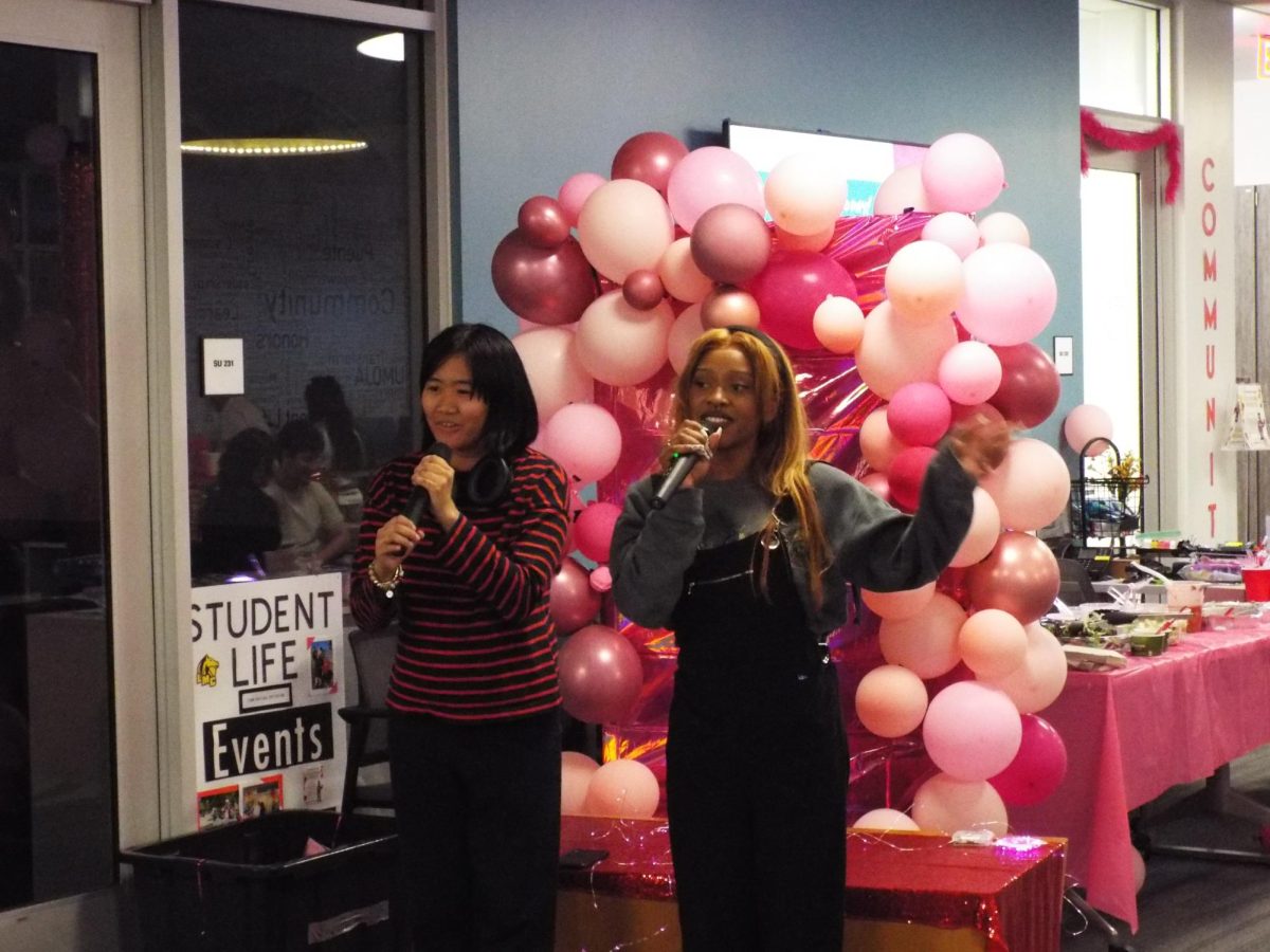 Los Medanos College students Lauren Gannod and Jesy Hernandez sing karaoke at the Galentines Day event held in the Student Union Feb. 15