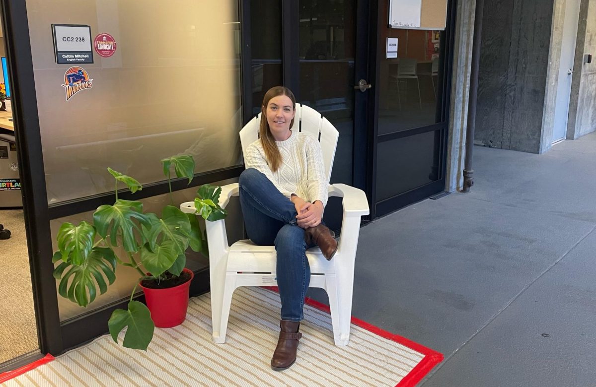 Caitlin Mitchell sits outside her office in her signature white chair.