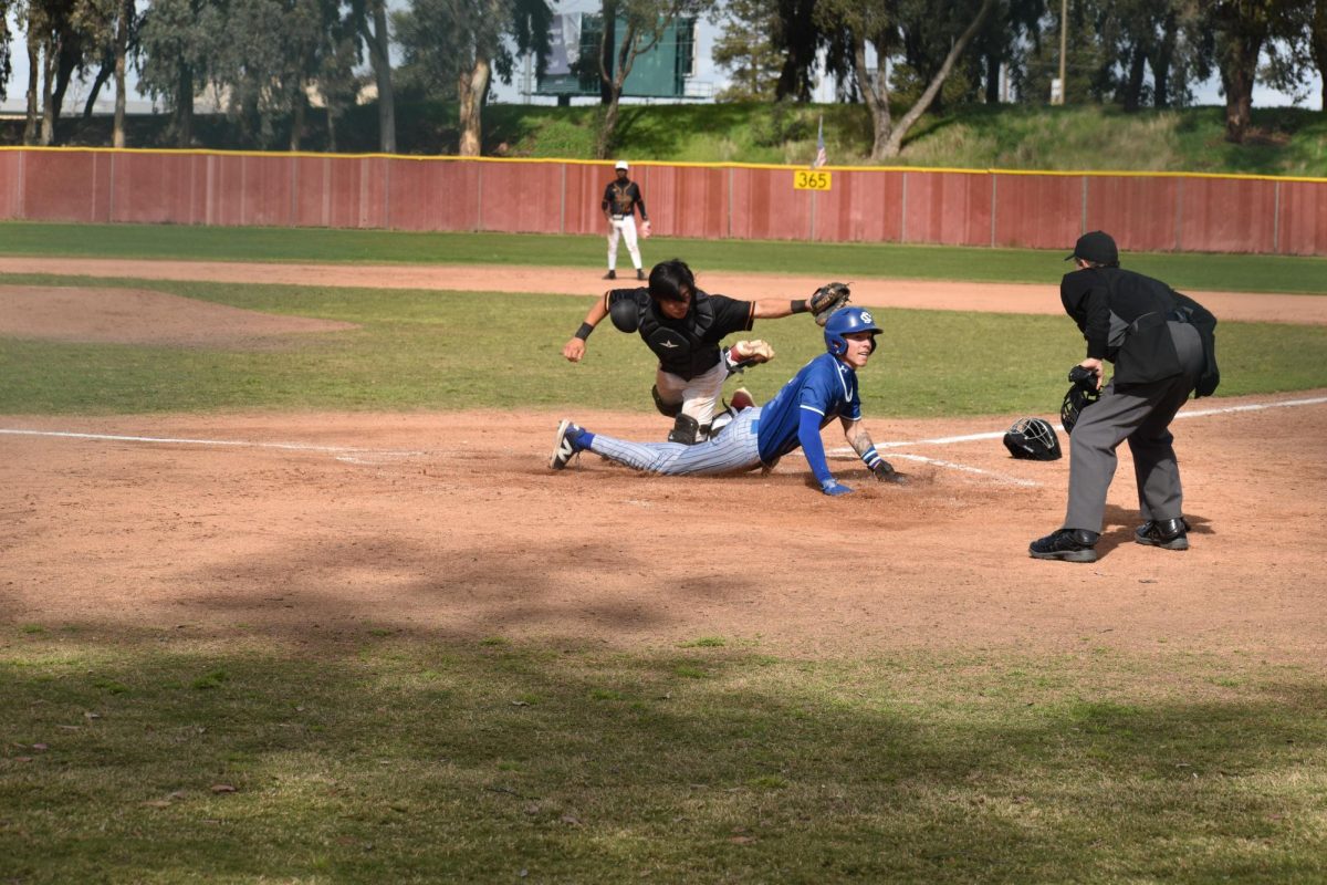 Los Medanos Catcher Yuto Sato tries to tag the Solano runner, but he slides in just before the tag.