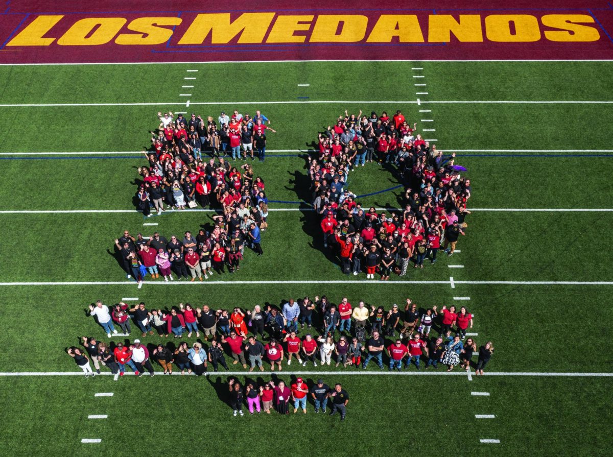 Los Medanos College staff gather on the football field to honor 50 years of the schools existence.