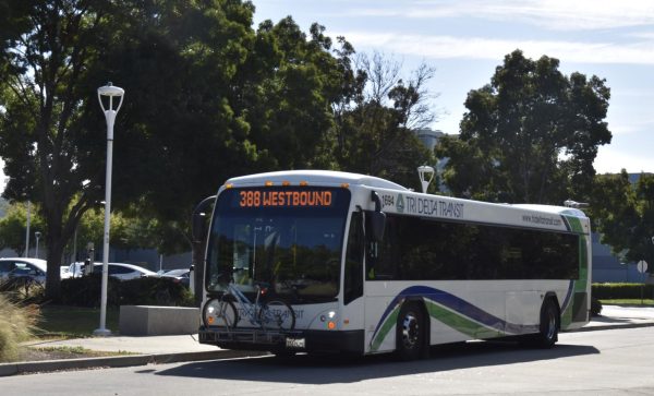 Students board and deboard a Tri Delta Transit bus in parking lot A.