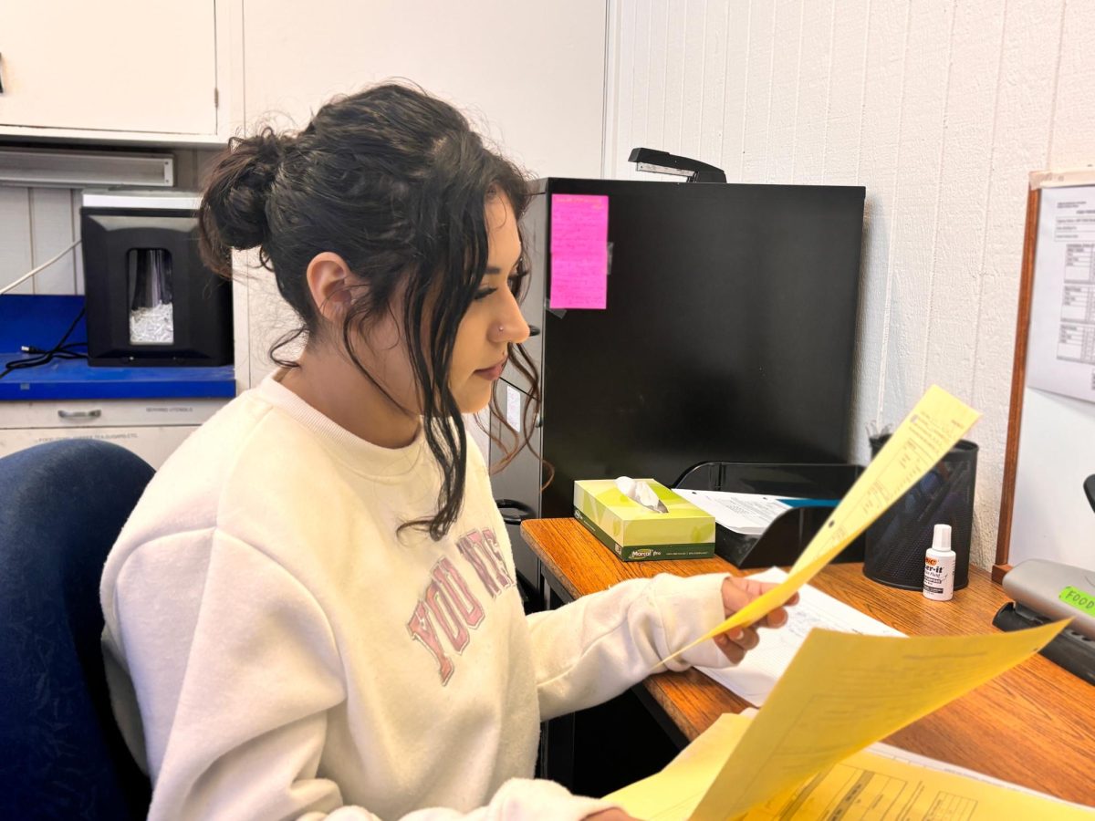 Chelley Hernandez doing paperwork for the Food Program at LMC