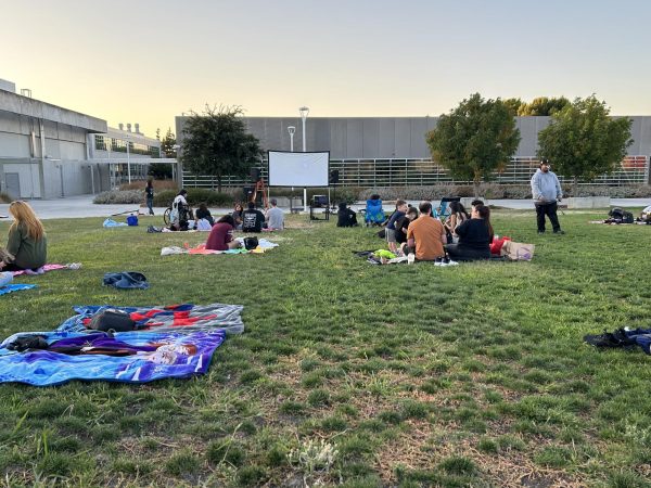 Attendants wait for the "Inside Out 2" showing to start of the campus field.