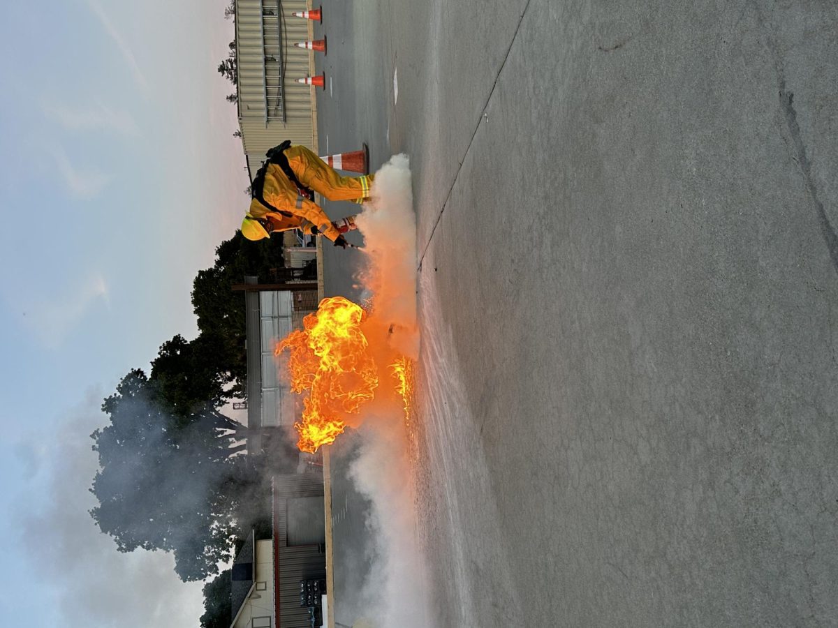 Los Medanos College Fire Academy student Tristian Otis puts out a fire in a demonstration of how to use a fire extinguisher.