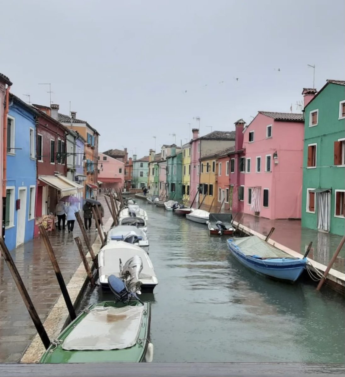 Colorful houses line a canal on Burano island in Venice, Italy.