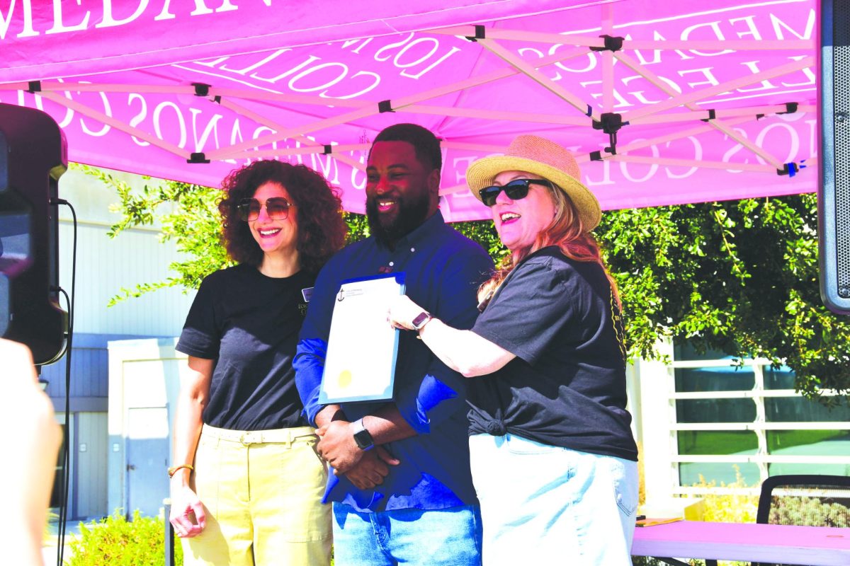 Chancellor Mojdeh Mehdizadeh and President Pamela Ralston accept proclamation from Vice Mayor Jelani Killings at the festivities before the homecoming game, Oct. 5.