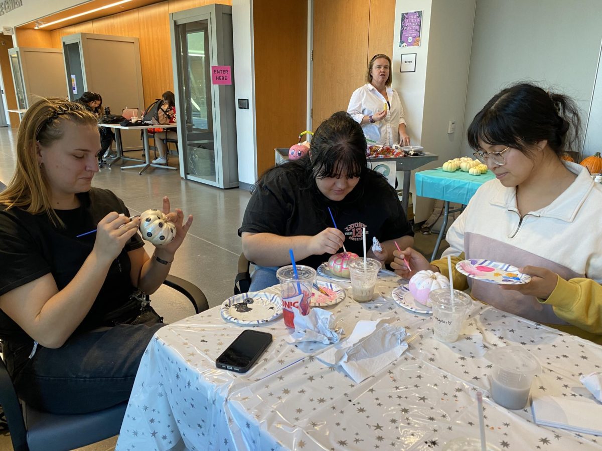 From left, student Khloe Josephsen, Patience Isch and Lucy Servantes paint pumpkins for the STEM fundraiser.