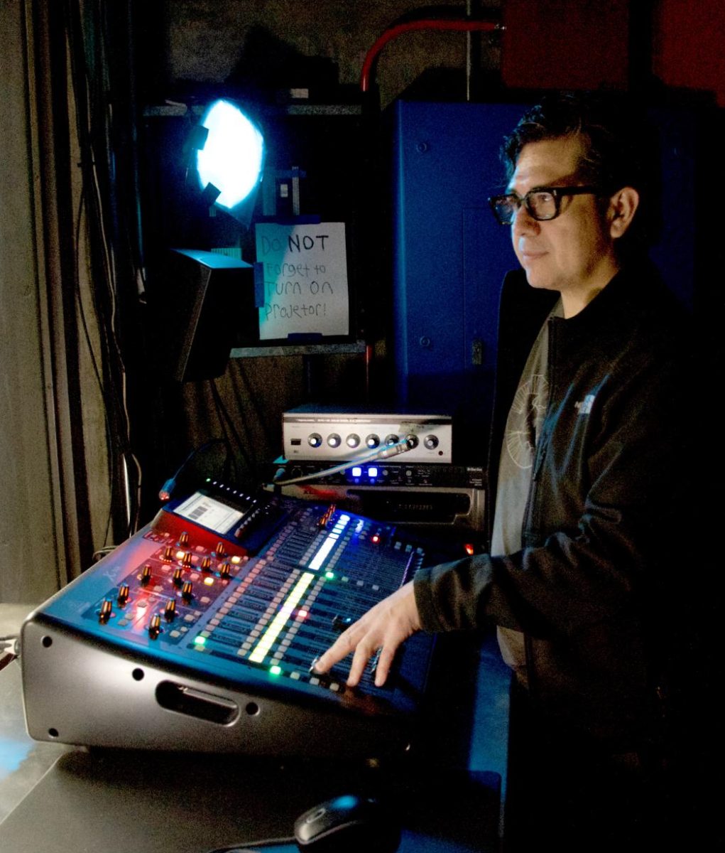 Cesar Reyes tests sound booth stage in the Drama Department’s Little Theater.