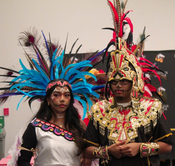 Puente students Stephanie Cuevas and Juan Pablo stand for the Dia De Los Muertos event at the Student Union Conference Room, Oct. 29.