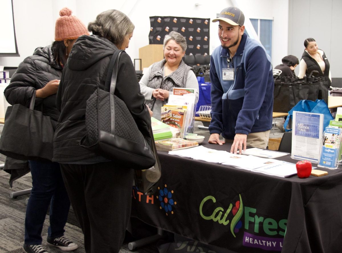 Health specialists Ana Villalobos and Mauricio Guerrero Villanueva from Contra Costa Health share recipes with students at the Friendsgiving Thanksgiving distribution Nov. 26 in the Los Medanos College Student Union Conference Center. 