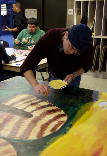 LMC student Jonelle Cabale helps to paint new mural honoring Native Americans.