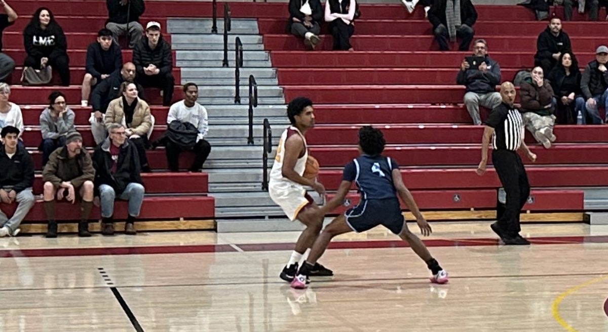 During last Friday's game No. 22 Diego Lopez scans the court for his game plan near the sideline with No. 4 Joseph Gould trying to break up his rhythm.