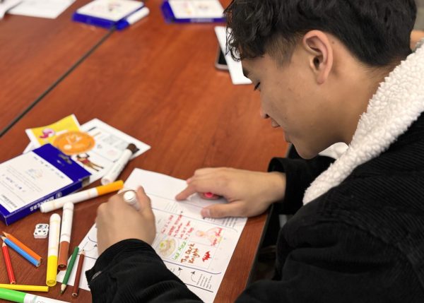 Student David Dudulao participates in the 'Art with Friends' event in the Pittsburg Library 109, Jan. 30.