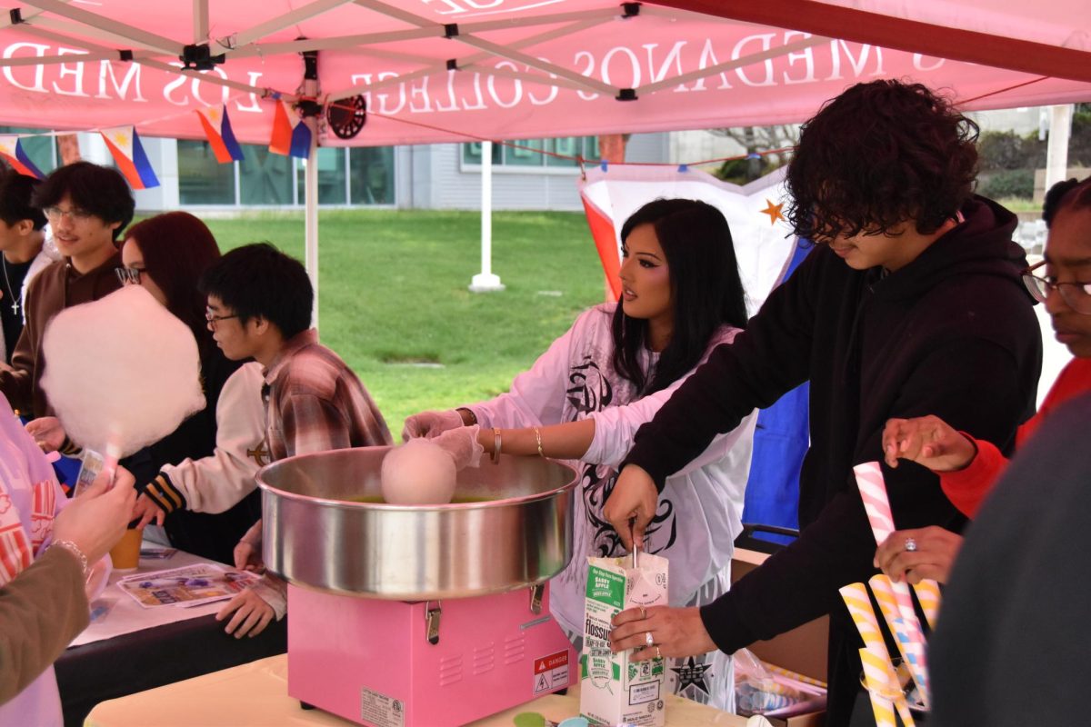 Members of the Kapwa club prepare cotton candy.