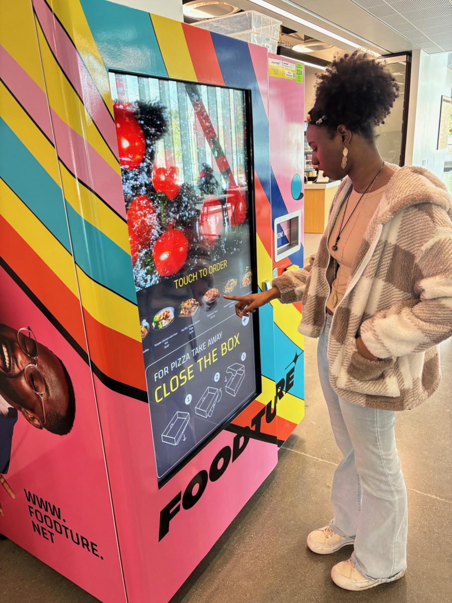 Student Mya Frazier orders food at hot vending machine on the first floor of the Student Union, March 14.