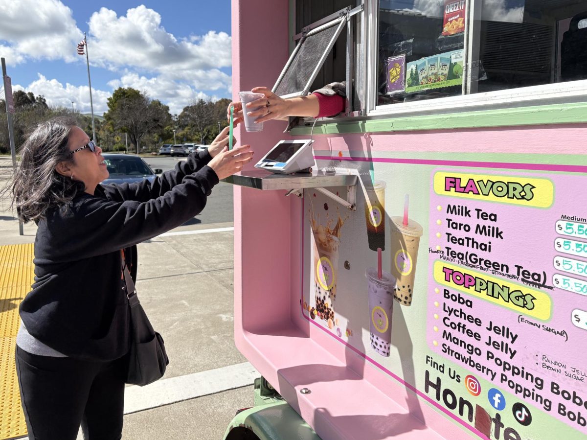 Norma Ocasio receives her order from Hon Teaboba truck on the Pittsburg campus in Parking Lot A.