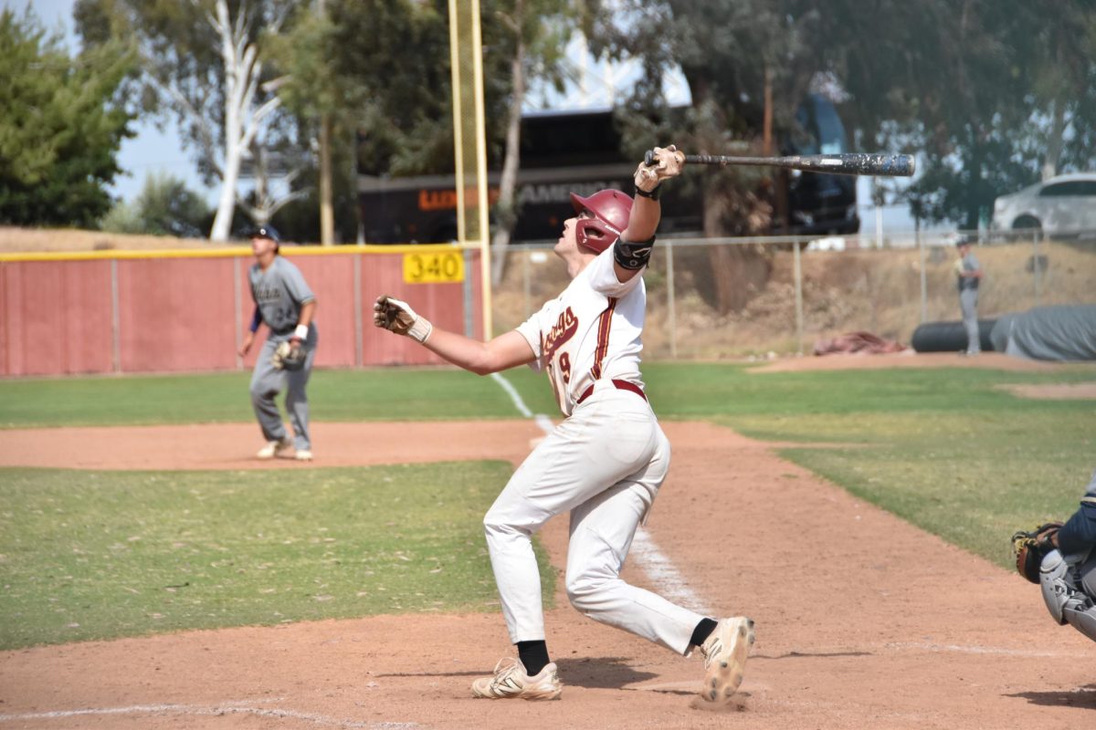 No. 9 infielder Charlie Malton pops a fly ball into left field in Tuesday's game agaisnt Yuba at home game, April 15.