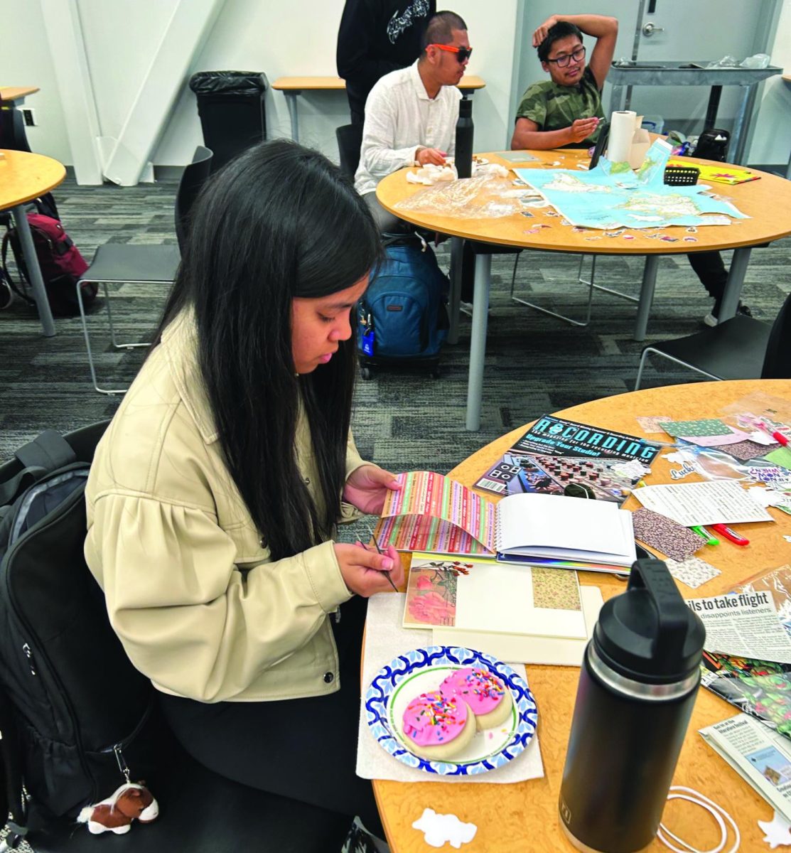 Student Kat Pangilinan creates a customized journal at the event in the Student Union Conference Center, April 16.