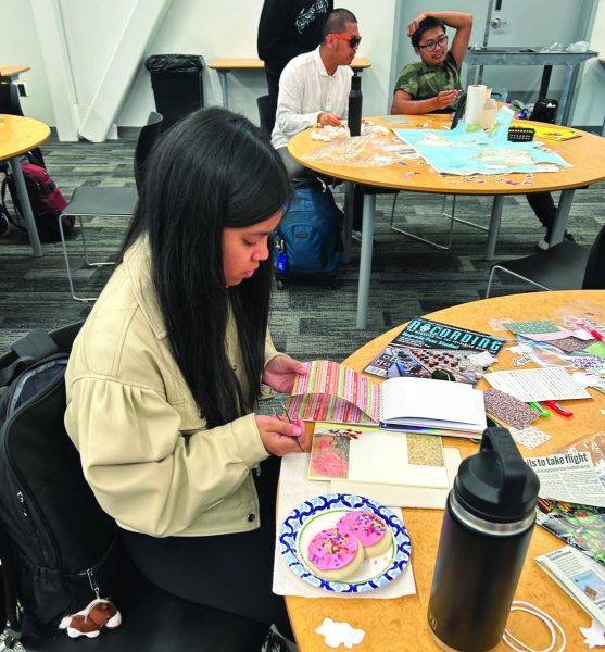 Student Kat Pangilinan creates a customized journal at the event in the Student Union Conference Center, April 16.