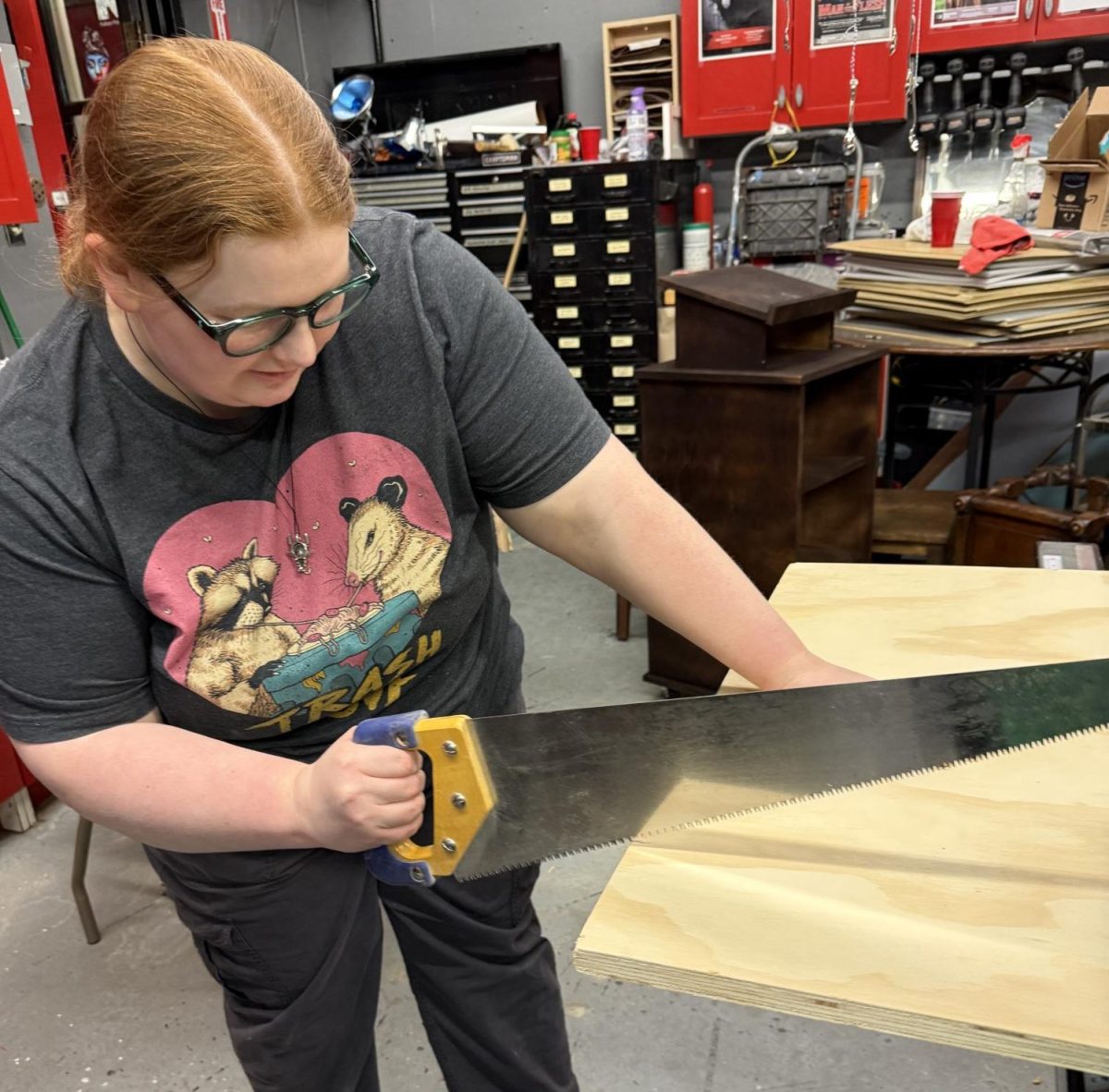 Set designer Hannah Dorr works on set for upcoming student-written play, titled “The Remnants.”