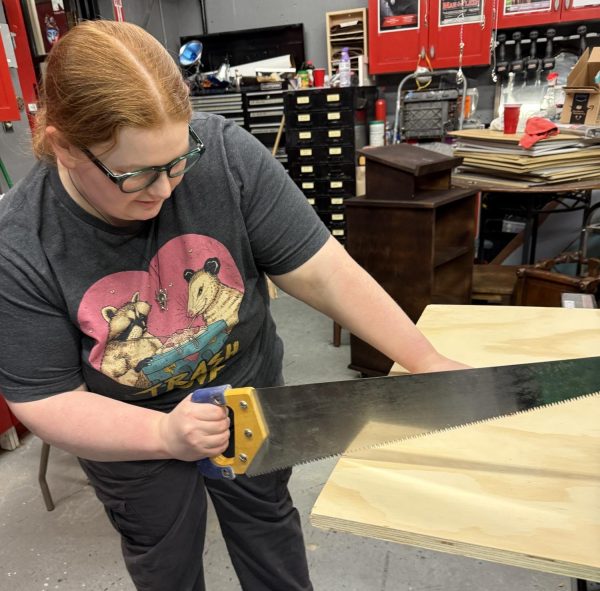 Set designer Hannah Dorr works on set for upcoming student-written play, titled “The Remnants.”