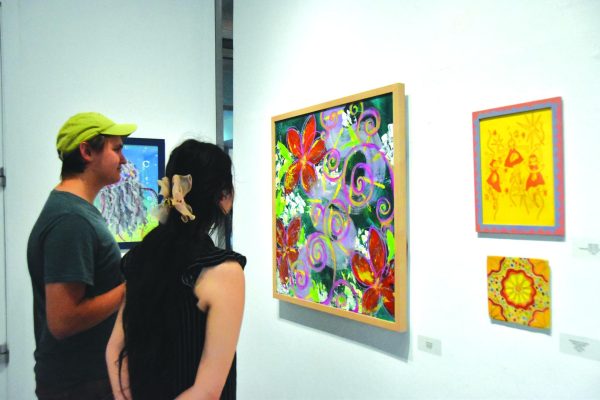 Attendees look at student art currently displayed in the Los Medanos College Art Gallery.