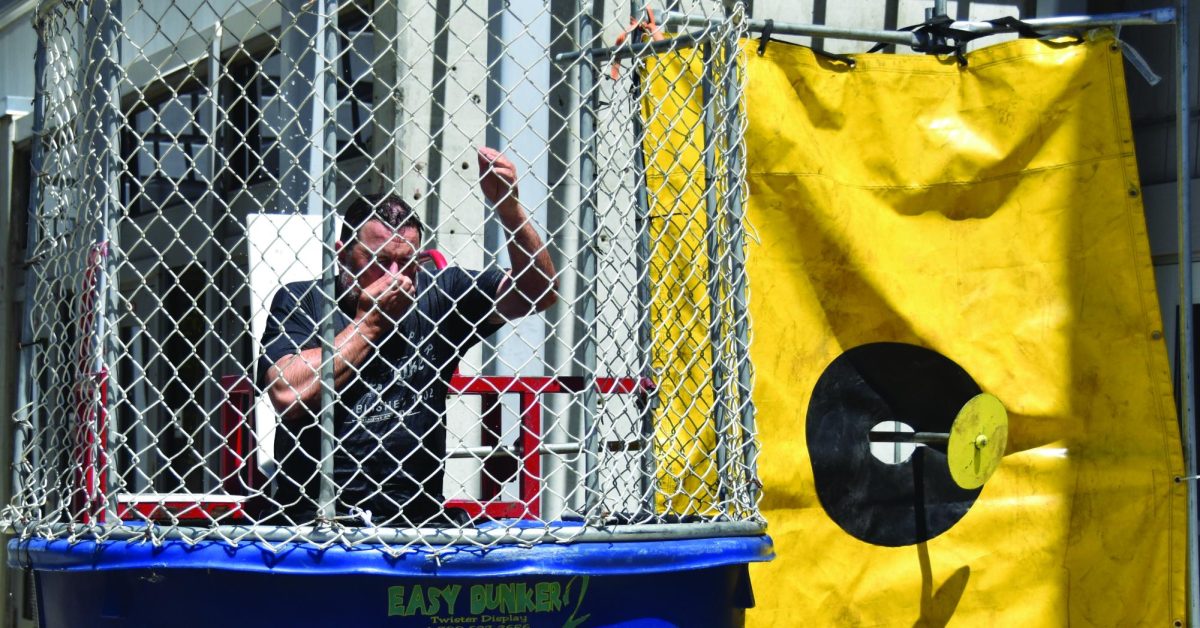 Dean Dennis Franco gets dunked at transfer fair event on Pittsburg campus quad, May 6.
