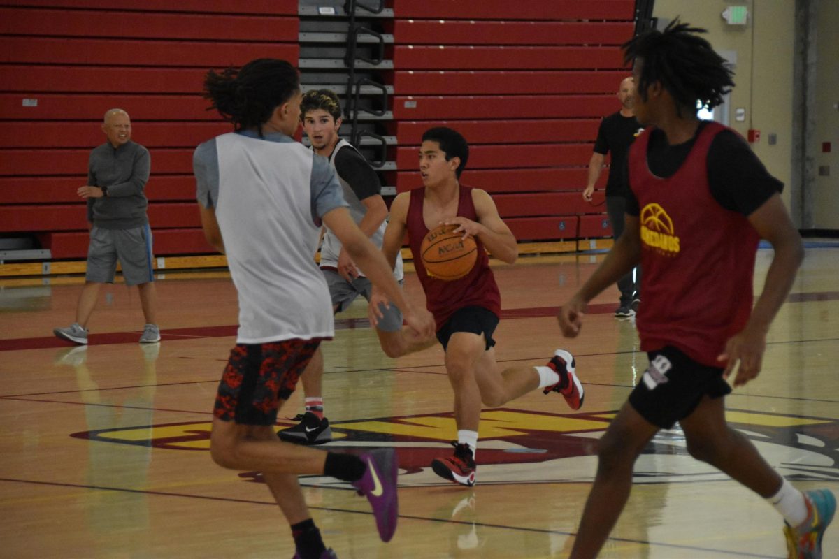 No. 30 Melquiades “Mateo” Ferolino dribbles the ball while no. 5 Gianni Altman gets back on defense in practice on Oct. 23.