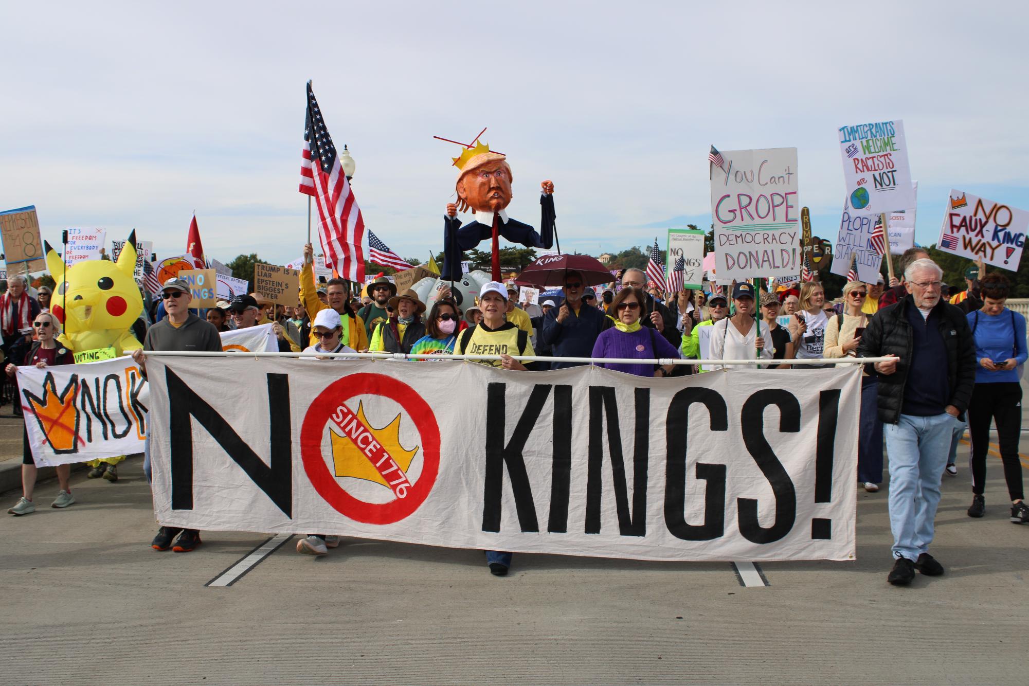 Protesters march across the Arlington Memorial Bridge into Washington D.C. during the 'No Kings' march Oct. 18.