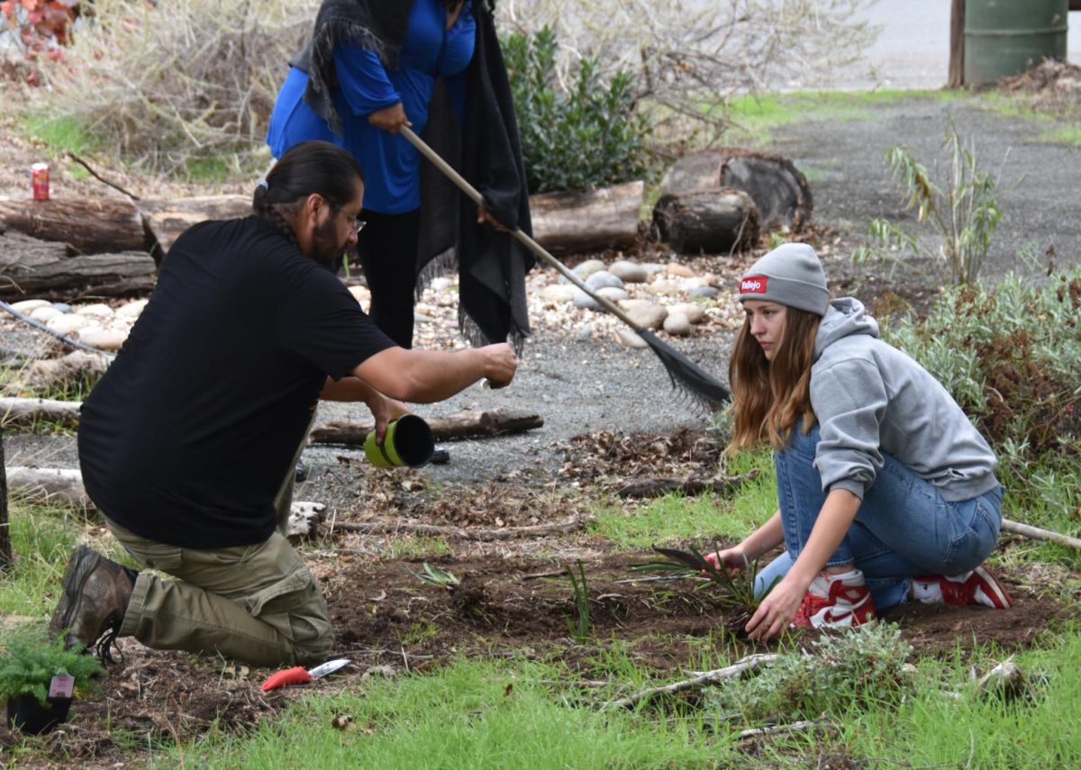 Preserve caretaker Ricardo Black works with an LMC student to keep the nature preserve clean.