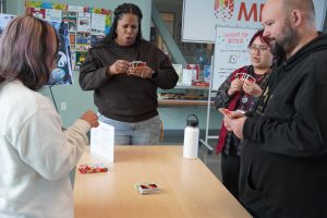 MESA Director Antoinette Corbin (Center) plays UNO with event attendees.