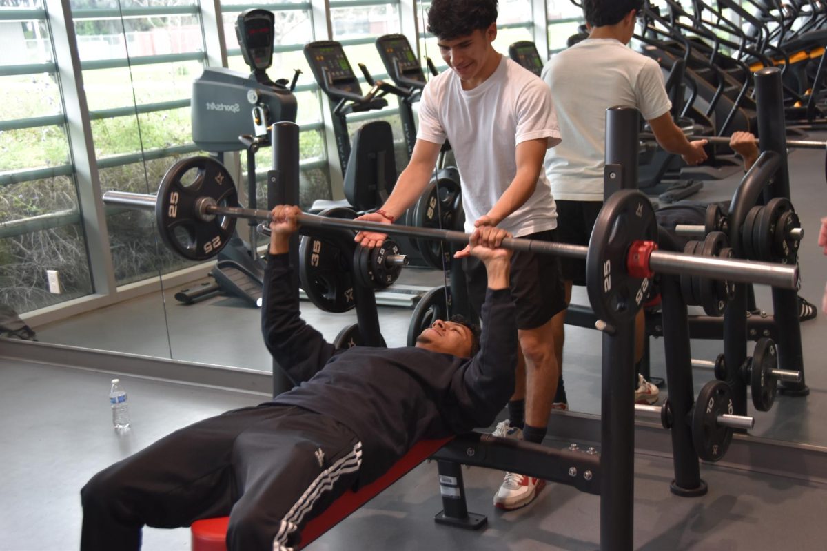 LMC Student Jose Antonio Sanchez and Diego Chacon work out using the benchpress in the LMC fitnesss center.